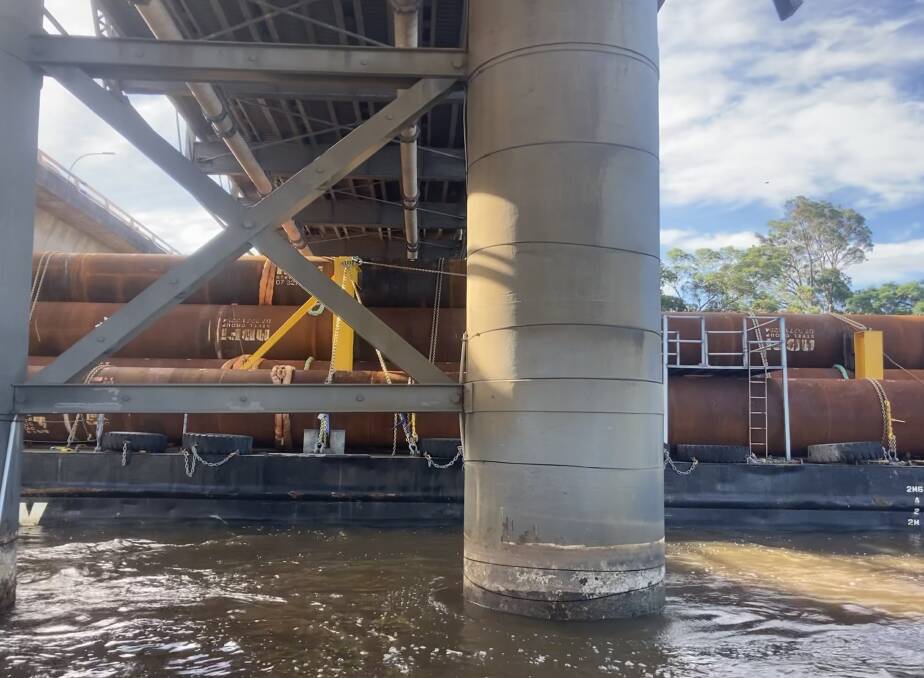CAREFUL NAVIGATION: The barge and its load manage to get under the two Shoalhaven River bridges. Image: Transport for NSW