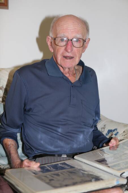 One of the oldest surviving Pyree Rovers players Greg Watts books through his scrapbook.
