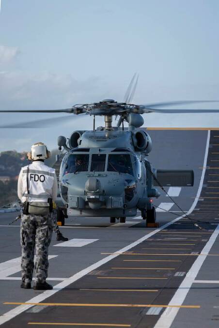 ON DECK: A Royal Australian Navy MH-60R Seahawk Helicopter on the flight deck of HMAS Canberra. Photo: Kylie Jagiello