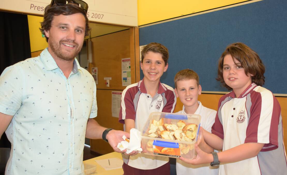 Assistant principal and Kidpreneur Market Challenge co-ordinator Troy Hosler makes a purchase from Max Mason, Declan Rogers and Charlie Walker.