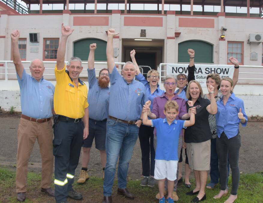 YOU BEAUTY: Nowra Show president Mark Stewart (centre), Shoalhaven RFS incident controller Superintendent Mark Williams, Shoalhaven Mayor Amanda Findley and members of the Nowra Show Society celebrate the news the 2020 show will go ahead and entry will be free. 