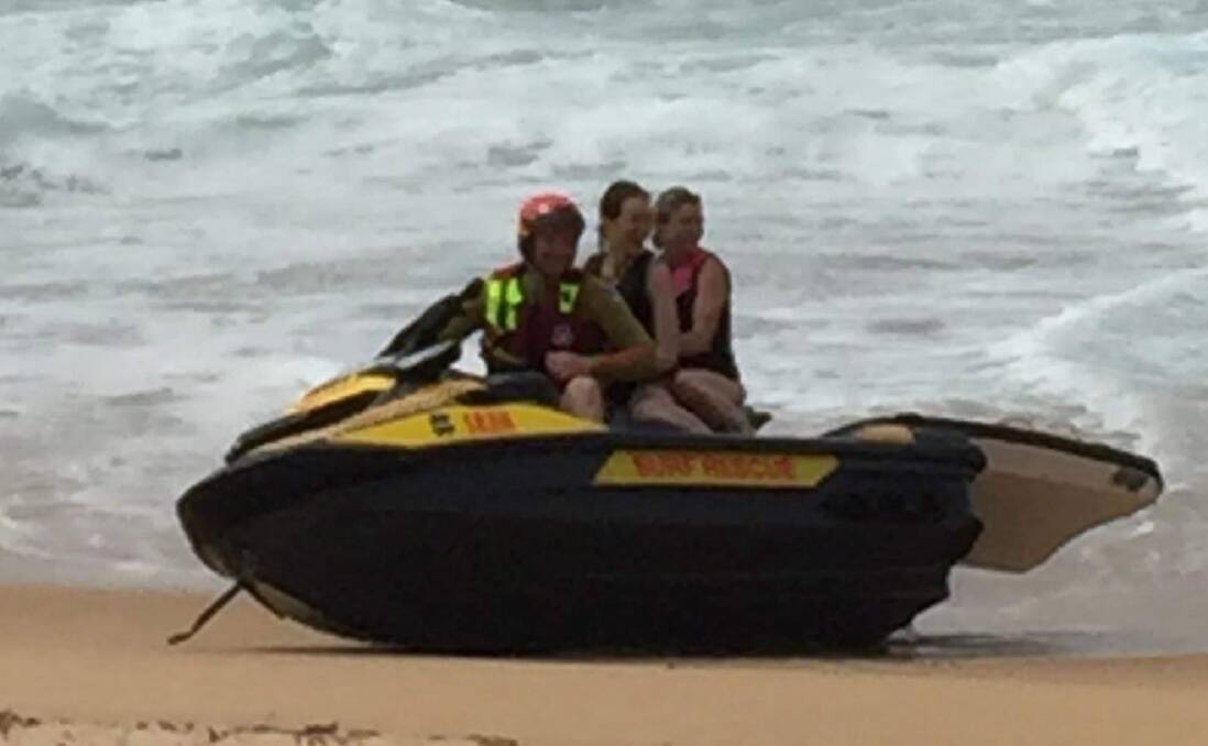  SAFE: Nowra-Culburra Surf Lifesaving member Josh Pakes safley back on firm ground with the two rescued paddleboarders. Image: Josh Pakes