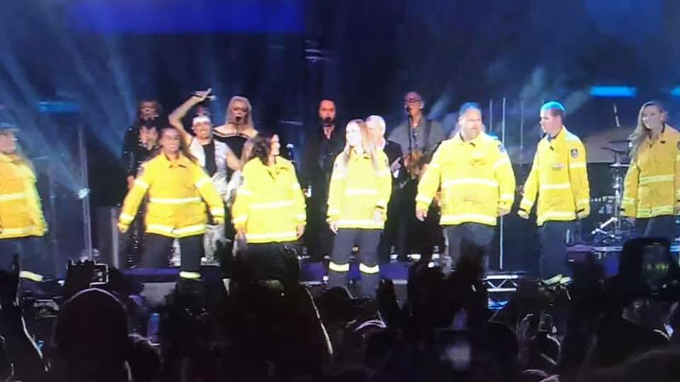 Shoalhaven RFS volunteers on stage at the Fire Fight Australia concert in Sydney.
