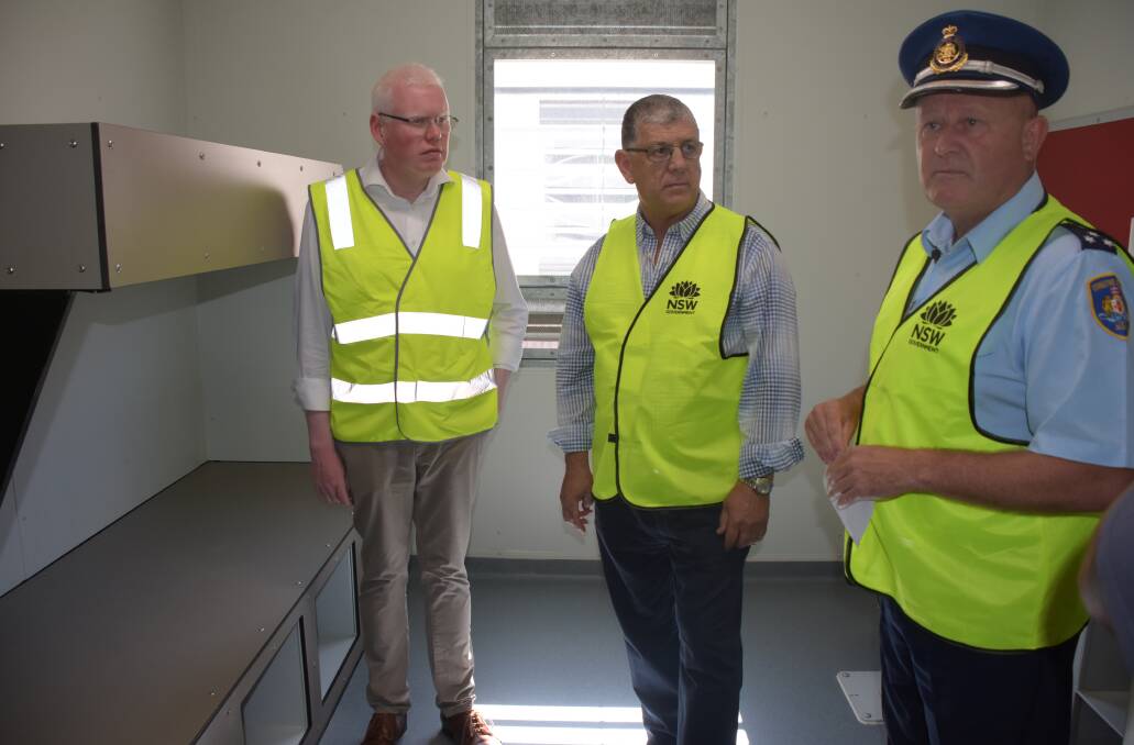 CELL BLOCK: South Coast Correctional Centre Governor Mick Reid (right) shows Kiama MP Gareth Ward and John Ajaka MLC one of the cells in the new 160-bed maximum-security wing.
