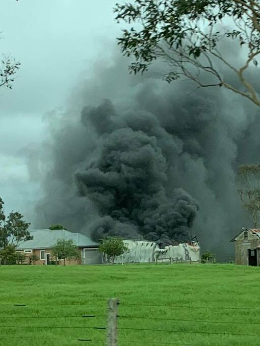 Thick black smoke billows from the shed fire at Worrigee on Sunday afternoon where two 17-year-olds suffered serious injuries. Photo Jo Bogle