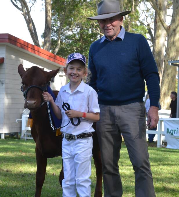 GOOD WIN: Six-year-old Lucy Cochrane leading Kangawarra Elaine tok out the under 10s junior paraders. She is pictured with the chief cattle steward and proud grandfather Alan Garratty.
