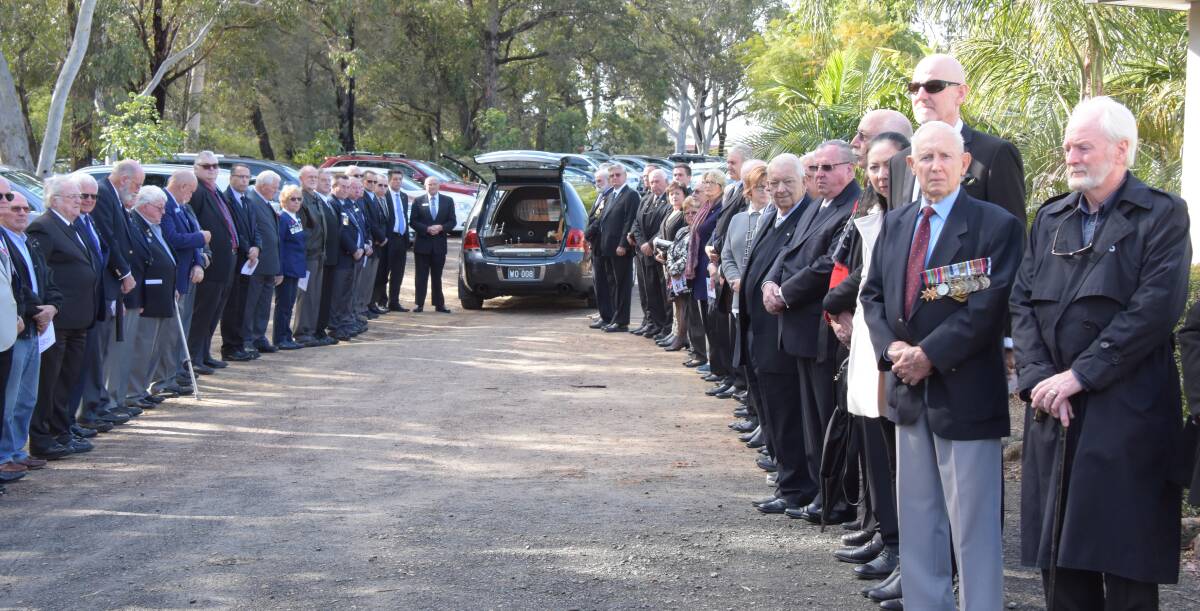 Local military personnel and community group members form a guard of honour at well-known local businessman Ian Strathie's funeral at the Nowra City Church on Monday.