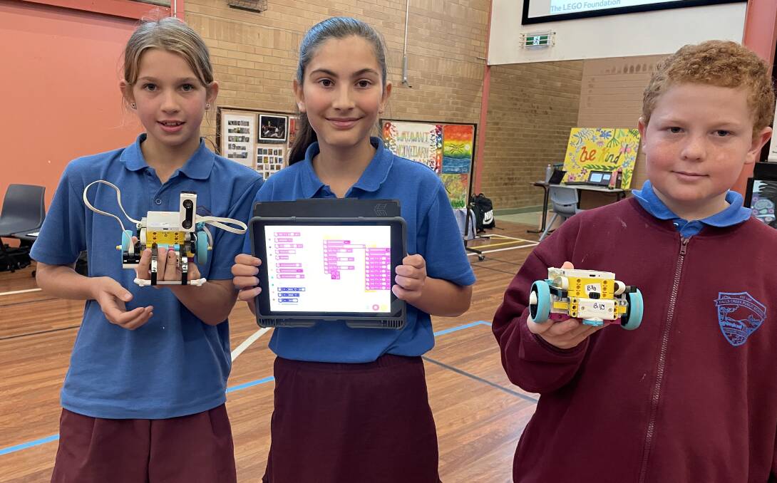 READY TO GO: Falls Creek students Keira Forster, Marley Murkins and Harley Stanmore with their robot projects.