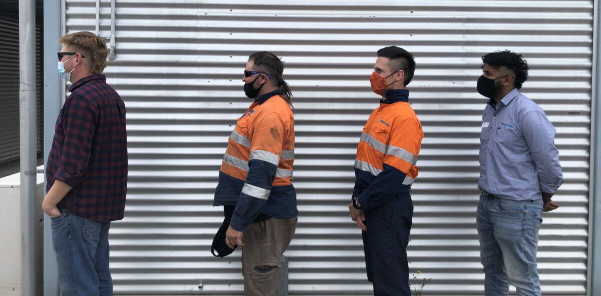 Fulton Hogan workers from the new Nowra bridge project show off their mullets.