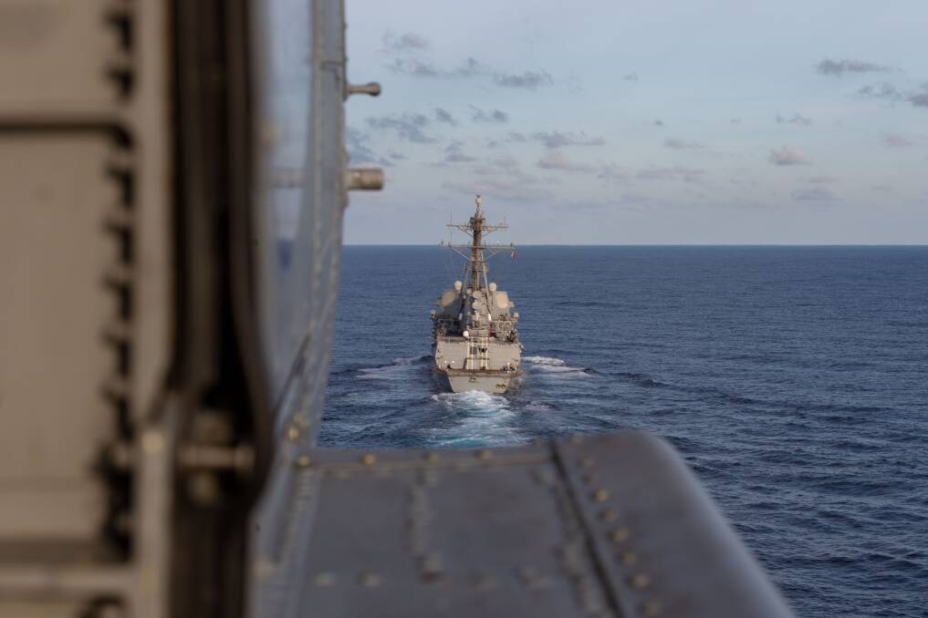 APPROACH: HMAS Ballarat's embarked MH-60R helicopter from HMAS Albatross makes an approach to land on USS Sterett during Exercise Malabar 2020. Photo: Shane Cameron
