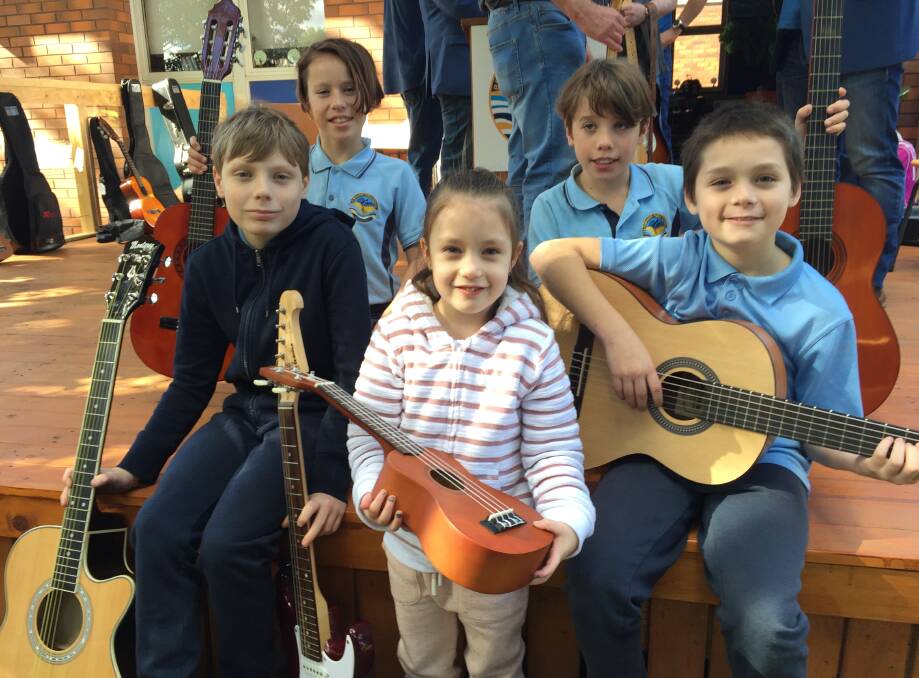 MUSIC LOVERS: Bomaderry Public students (from left) Dustin Peters, Charlotte Whittaker, Alexis Peters, Sam Whittaker and Logan Peters with their new guitars courtesy of the ACT-based Soldier On Music Group.