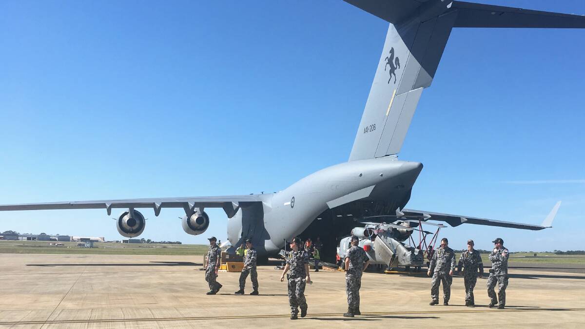 One of the Romeo helicopters is loaded a board a Royal Australian Air Force C-17 aircraft on before heading to Scotland.