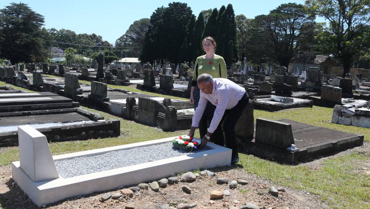 FAMILY: Tony Longbottom and Biddy Adams lay a wreath at Mr Longbottom's four-time great uncle Robert Kearns' grave.
