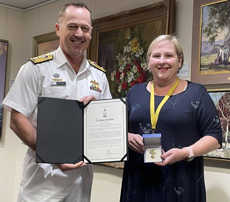 WELL-DESERVED: Commanding Officer of the Fleet Air Arm, Commodore Dave Frost presents Royal Australian Navy Fleet Air Arm Museum and Royal Australian Naval College Museum at HMAS Creswell collections curator, Ailsa Chittick with her Navy Commendation on behalf of Chief of Navy, Vice Admiral Michael Noonan.