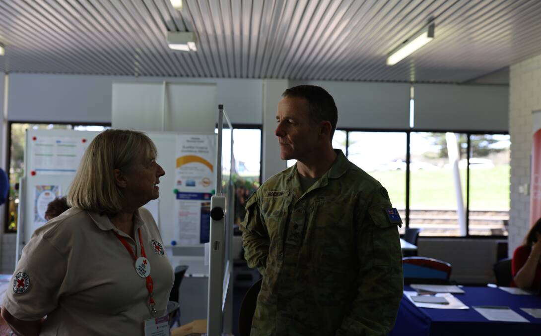 National Bushfire Recovery Agency deputy coordinator Major General Andrew Hocking chats with Red Cross representative Joycelyn Bowles at Ulladulla. 