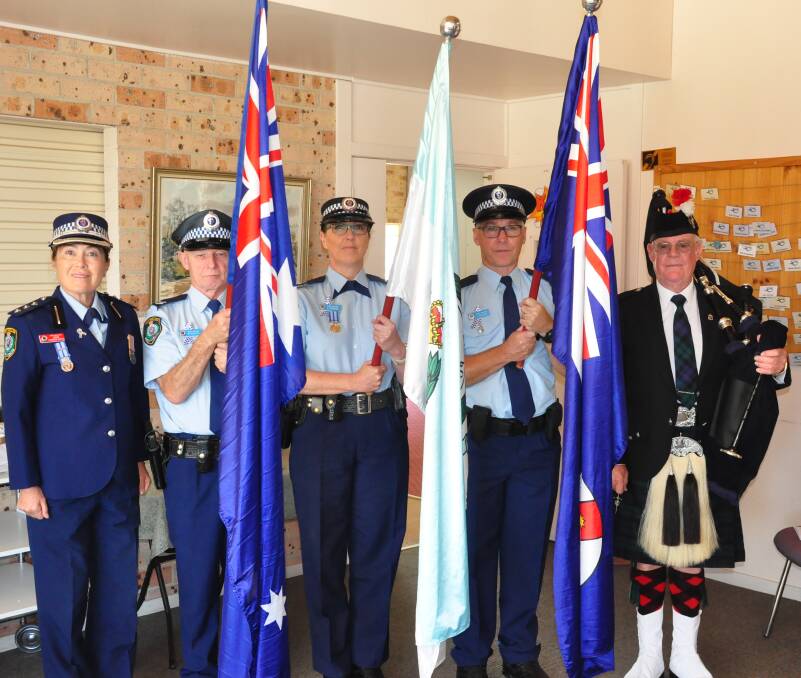 HONOUR: Chief Inspector Sue CharmanHorton and Nowra Pipe Band Pipe Major Roger Chapman with the flag party at South Coast Police District Remembrance Day Senior Constable Mick Roberts, Senior Constable Vicki Ferraris and Senior Constable Jason Gosling.