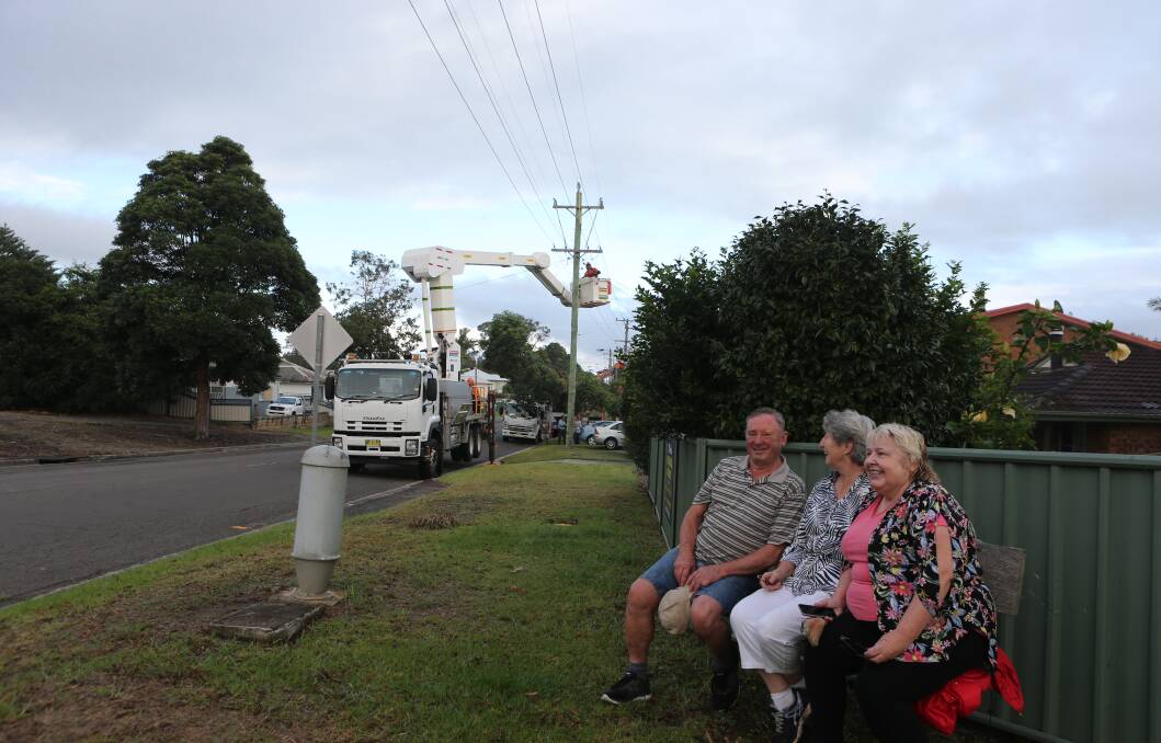 Greenwell Point locals Ron and Carol Davies and Sue Greenwood watch as Endeavour Energy crews do their work.