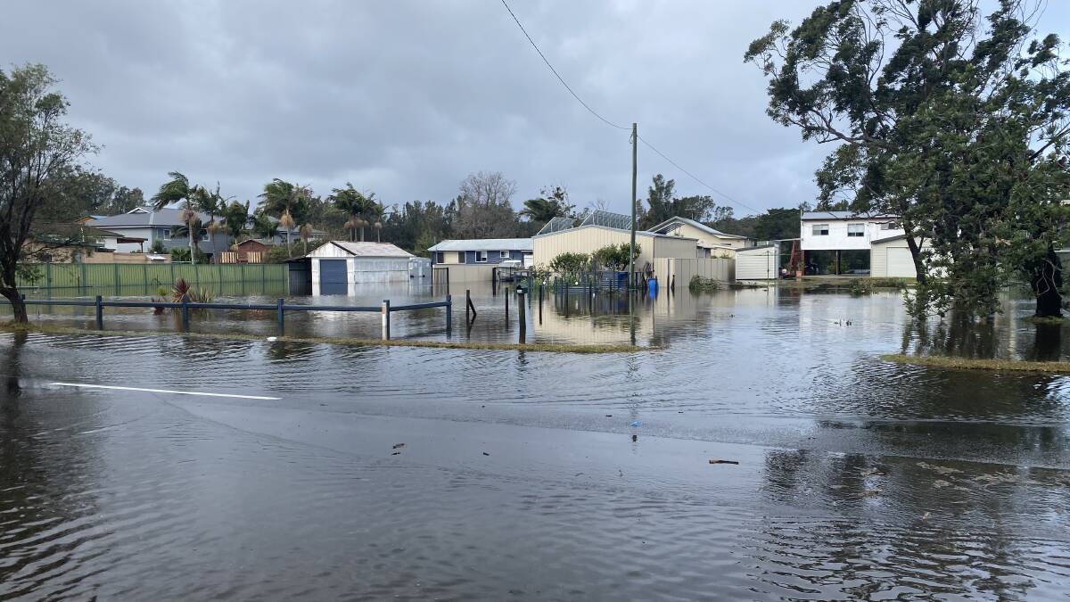 WET: Some of the homes on River Road, Sussex Inlet, inundated by floodwaters.
