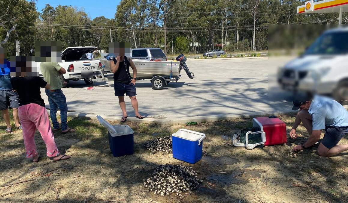 SEIZURE: NSW DPI Fisheries officers inspect the seized cockles at a service station at Wandandian.