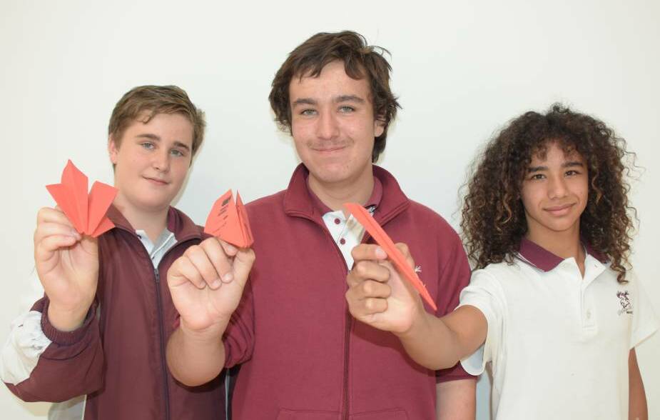 READY TO FLY: Vincentia High's Daniel Williamson, Stuart Young and Keanu King ready to take to the air in last year's inaugural Sikorsky Australias Plane Simple paper plane competition.