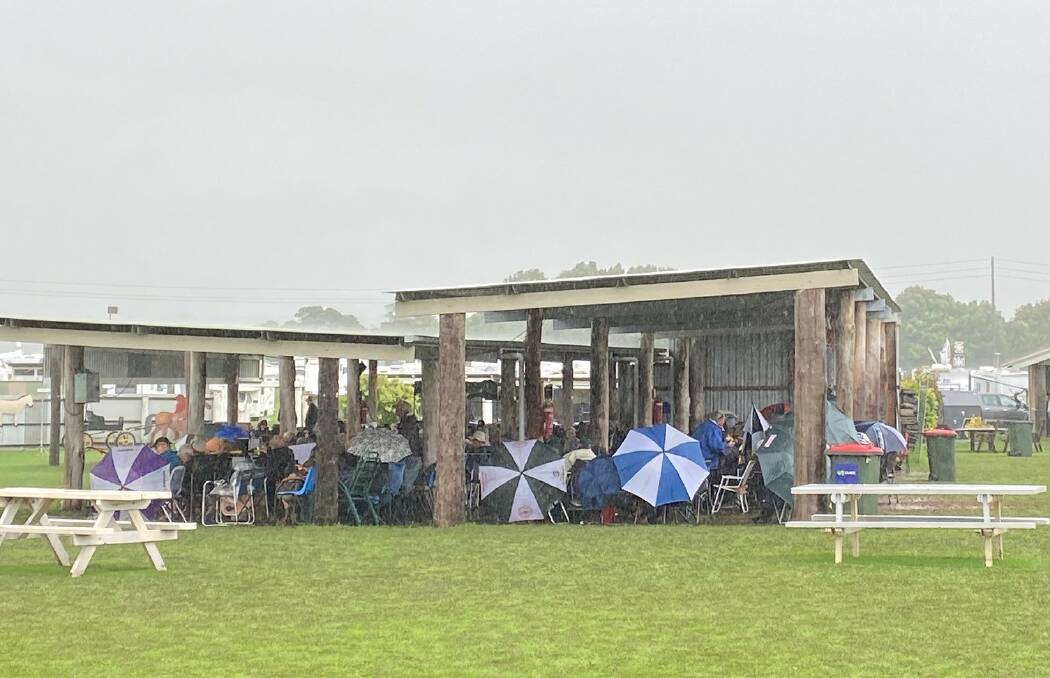 TAKING SHELTER: Terara Country Music Campout fans stay dry under cover as the show goes on.
