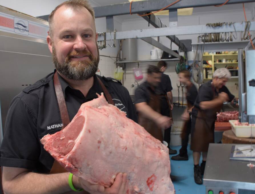 BUSY TEAM: Nathan Alcock, who this weekend represents NSW at the State Butchers' Challenge, with his busy team at North Nowra.