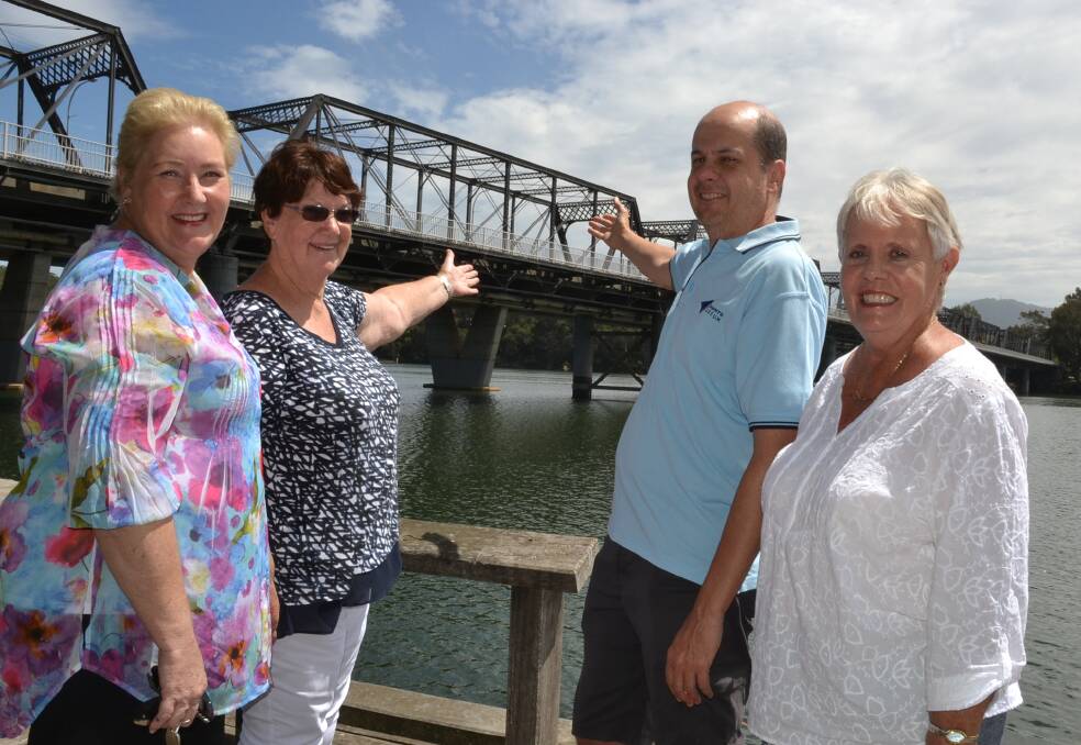 SAVED: Gilmore MP Ann Sudmalis, Shoalhaven Historical Society life member Robyn Florance, secretary Tim Rigney and vice-president Gerri Walker celebrate the news Nowra's historic iron bridge over the Shoalhaven River is to be saved.
