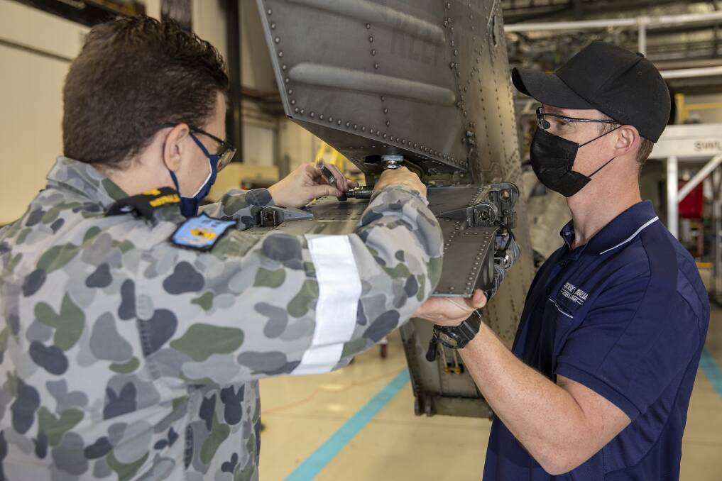 JOINT EFFORT: Sikorsky Australia aviation technicians are embedded on base with the navys MH-60R Seahawk 725 and 816 squadrons at HMAS Albatross, together sustaining the fleet of Romeo helicopters. Image: Supplied