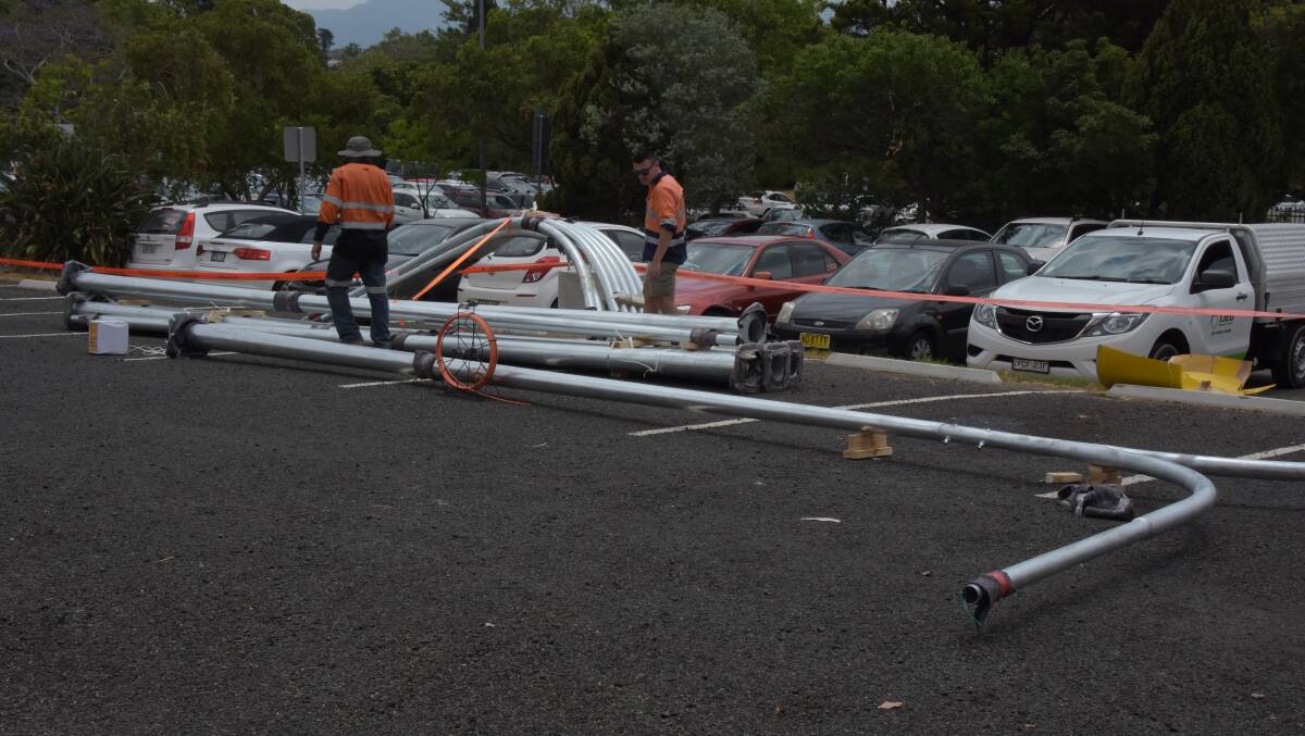 BRIGHT SPARKS: Local contractors from IJED Electrical and Data installing eight new 200W LED car park lights in the Collins Way / Osborne Street car park in Nowra CBD for Shoalhaven City Council.