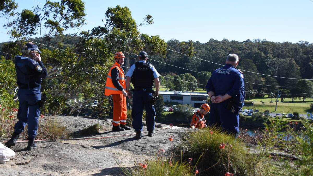 Emergency services work to recover a man’s body from the bottom of a cliff adjacent to the Shoalhaven River in Nowra.