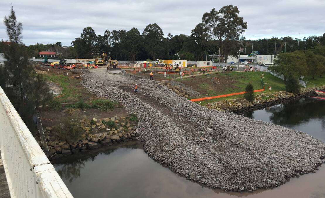 CONSTRUCTION SITE: A large stone base platform area juts out from the southern foreshore of Shoalhaven River as the start of the $342 million new Nowra bridge.
.

