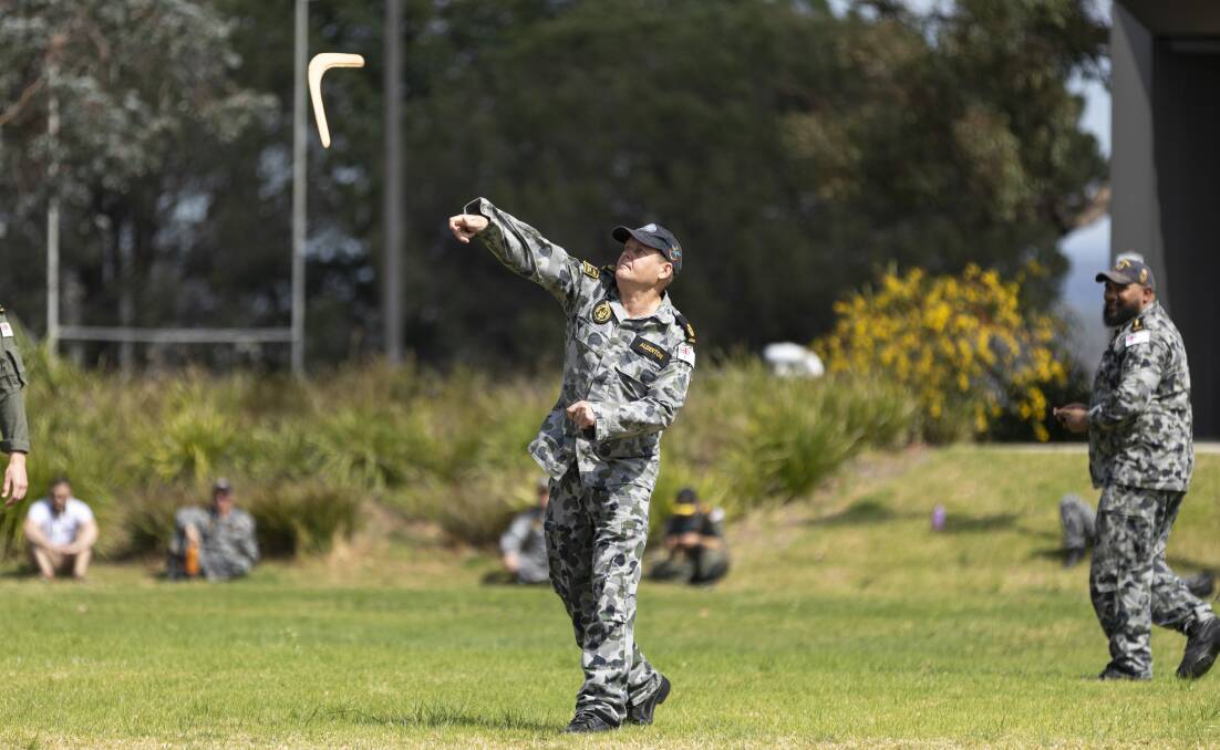 HAVING A GO: Chief Petty Officer Combat Systems Manager John Alderton throws a boomerang during a cultural immersion workshop at HMAS Albatross. Photo: Jarrod Mulvihill