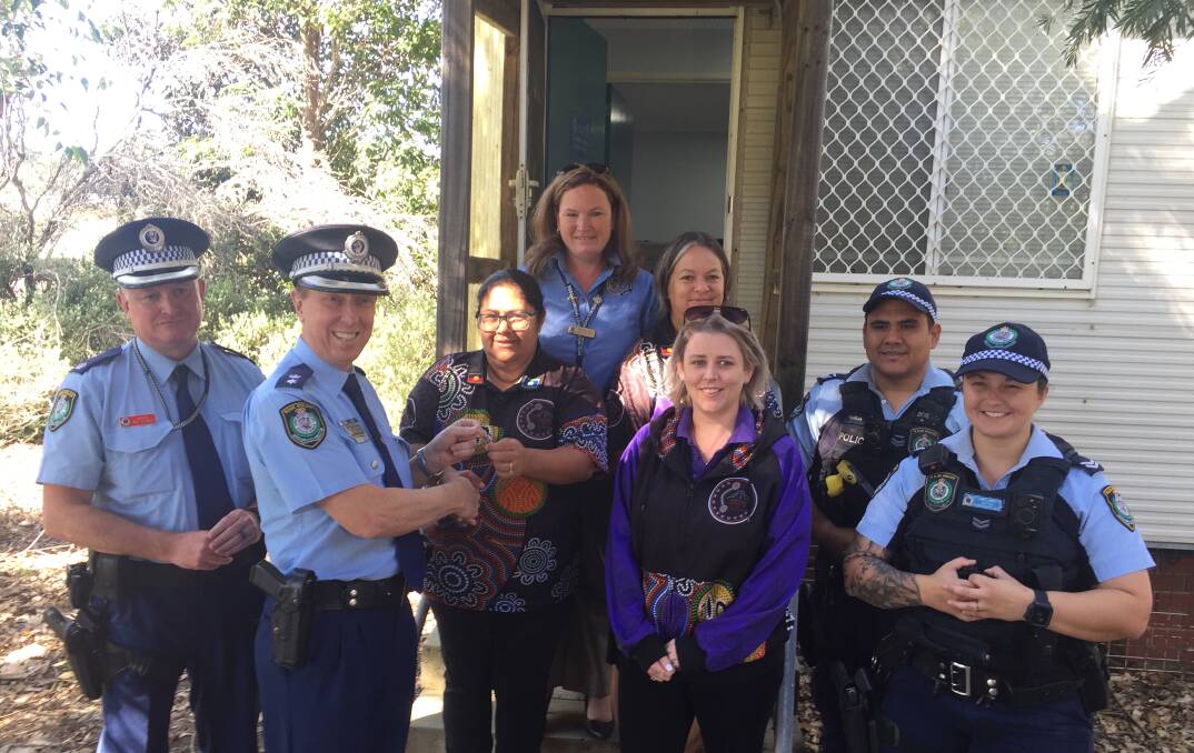 ALL YOURS: South Coast Police District Superintendent Greg Moore presents the keys to the former Culburra Police Station to Cullunghutti Aboriginal Child and Family Centre CEO Tara Leslie, watched by officer in charge of Nowra Police Station, Inspector Ray Stynes, Nowra Police Aboriginal Community Liaison Officer (ACLO) Viv Sweeny, Cullunghutti disability support worker Amy Smith, community engagement worker Tina Seymour and current Culburra officers Senior Constable Cesar Pareja and Senior Constable Jess PIckering.