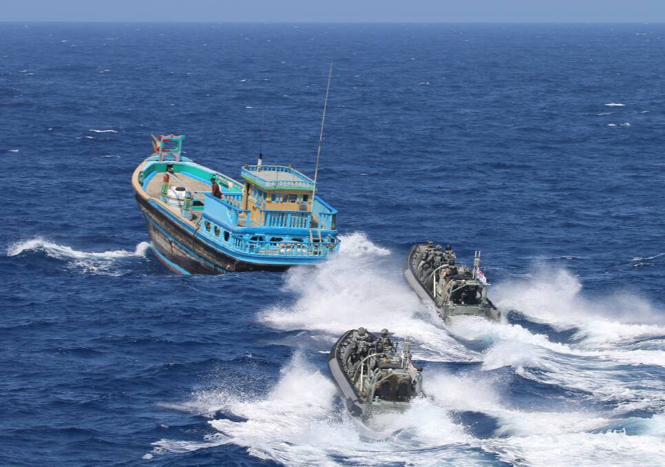 HMAS Ballarat's boarding party close on a suspicious dhow for a boarding which resulted in the seizure of approximately two and a half tonnes of illicit drugs. Photo: Bradley Darvill
