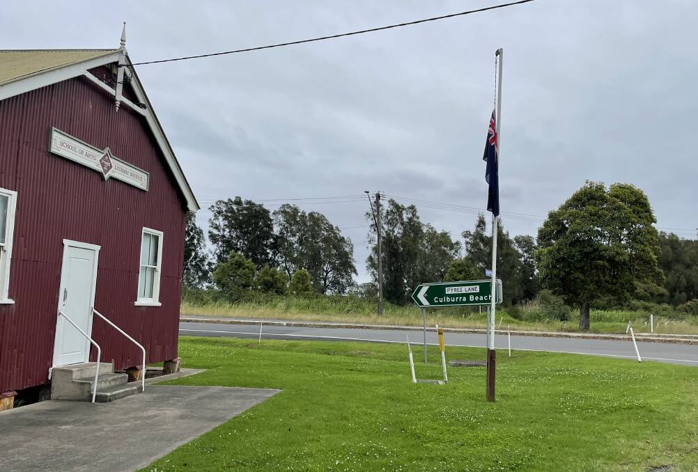 RESPECT: The flag at Pyree Literary Institute flew at half mast on Remembrance Day, as it did almost 100 years ago when the initial memorial tree (far right) was planted at the intersection of Pyree Lane and Greenwell Point Road.