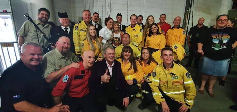 ROCK ROYALTY: Shoalhaven RFS volunteers Leroy Lidbetter (front right), Amanda Saxton (next to John Farnham), Casey Addison (directly behind) and Brett Thomas (right of Olivia Newton-John) backstage after the Fire Fight Australia concert in Sydney.