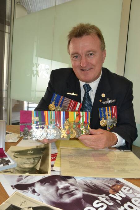 Nowra RSL secretary Rick Meehan with Victoria Cross recipient Kevin “Dasher” Wheatley’s medals and some of the family’s treasures which have been made available to be shown to local school children.
