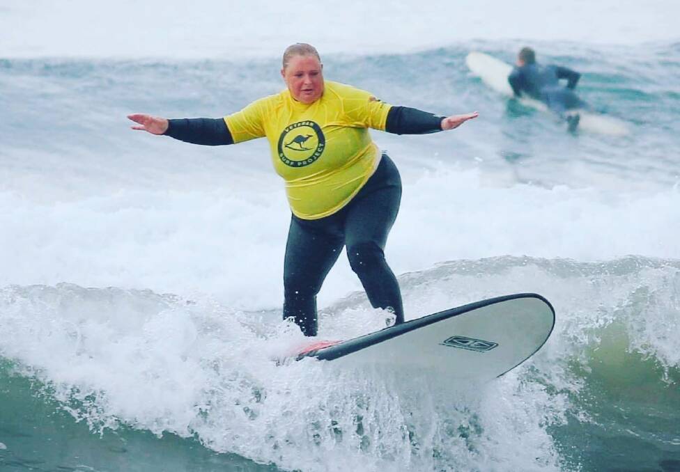 WOOHOO: Shoalhaven chiropractor, Dr Kate Daniel takes to the waves with the Veteran Surf Project.
