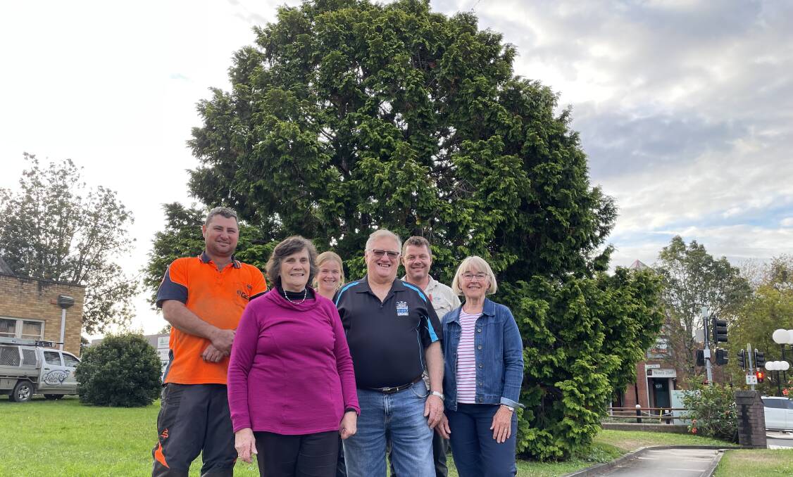 GREAT PROJECT: Chris Hobbs, of C&S Tree Services, Uniting Church Council secretary Cathie Cochrane, Holly and Mick Finch, of SchMick Energy, Shoalhaven Suicide Prevention and Awareness Network (SSPAN) chairperson Bruce Murphy and educator Fiona Statsiukynas in front of the large conifer in the Nowra CB which will be lit up as part of the Blue Tree Project.