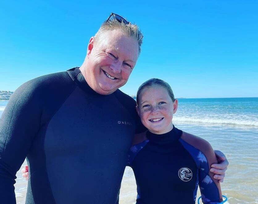 WAVE TIME: Craig Daniel with his 12-year-old daughter Emmi after a recent surf.