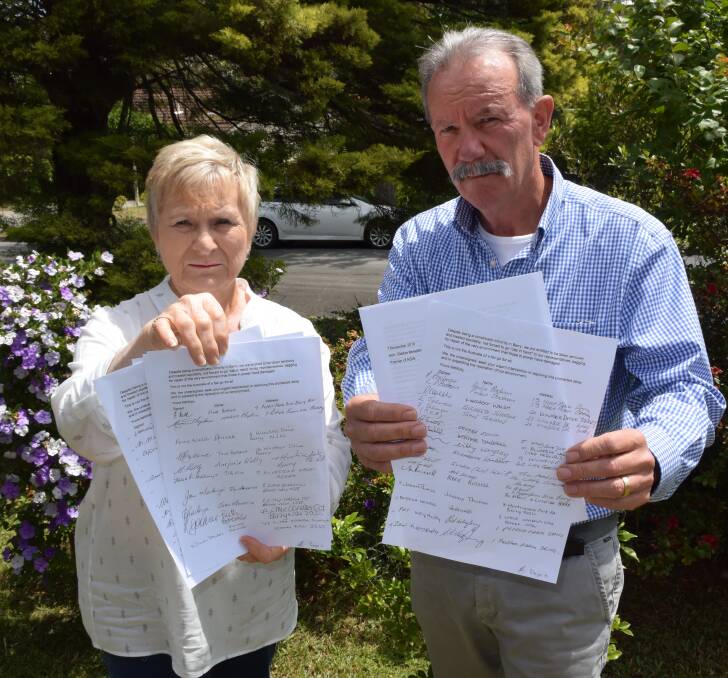 FIGHT: Berry residents Tina Ballard and Nic Delfos with the letter to be sent to Premier Gladys Berejiklian signed by 64 residents affected by the noise from the bypass. Photo: Hayley Warden