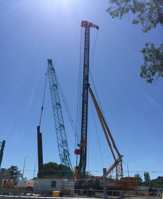 BIG: Two pylons were being out into place by the piling rig and crane for the new four lane $342 million Nowra bridge on Friday.