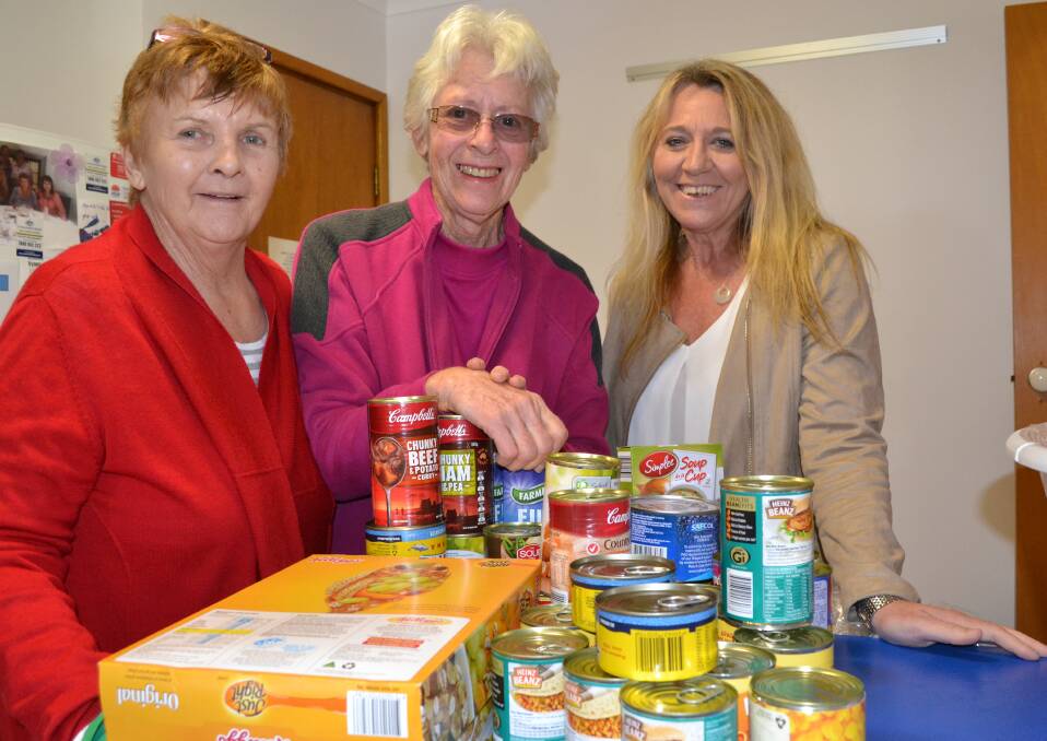 HUGE RESPONSE: Far Meadow resident Nerell Kelly (centre) donates food items to Shoalhaven Homeless Hub manager Kerri Snowden (left) and co-ordinator Julie Bugden.