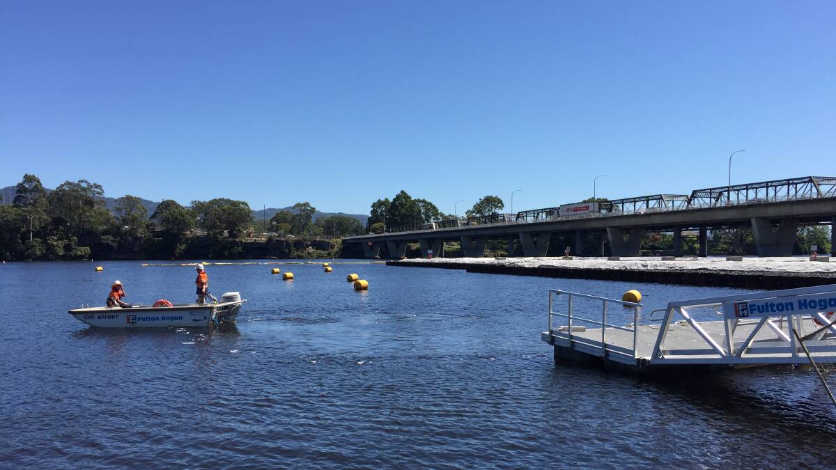 EXCLUSION ZONE: For the safety of workers and river users, a marine exclusion zone on the Shoalhaven River is marked by safety buoys and signage during piling work and pier construction.