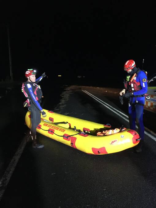 RESCUE TEAM: Shoalhaven-based NSW Ambulance paramedic Irwin Burbage (left) and his SES counterpart prepare to rescue a man stranded in floodwaters on Bolong Road in the early hours of Monday morning.