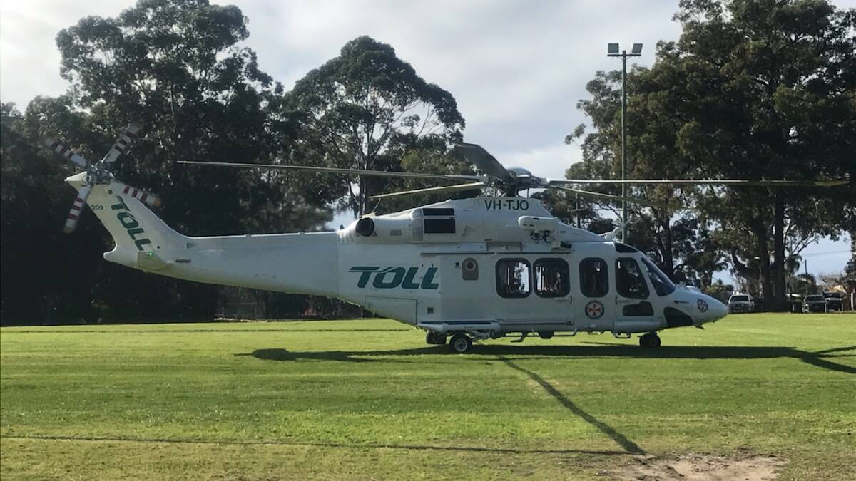 RESCUE FLIGHT: The Wollongong-based Toll NSW Ambulance rescue helicopter at the Huskisson football field on Sunday morning before airlifting an injured female horse rider to St George Hospital.