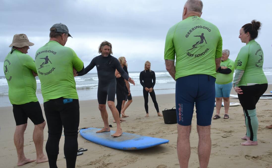 ON THE BEACH: Veterans Surfing Program co-ordinator Rusty Moran takes the initial participants in the pilot program through some surfing basics.