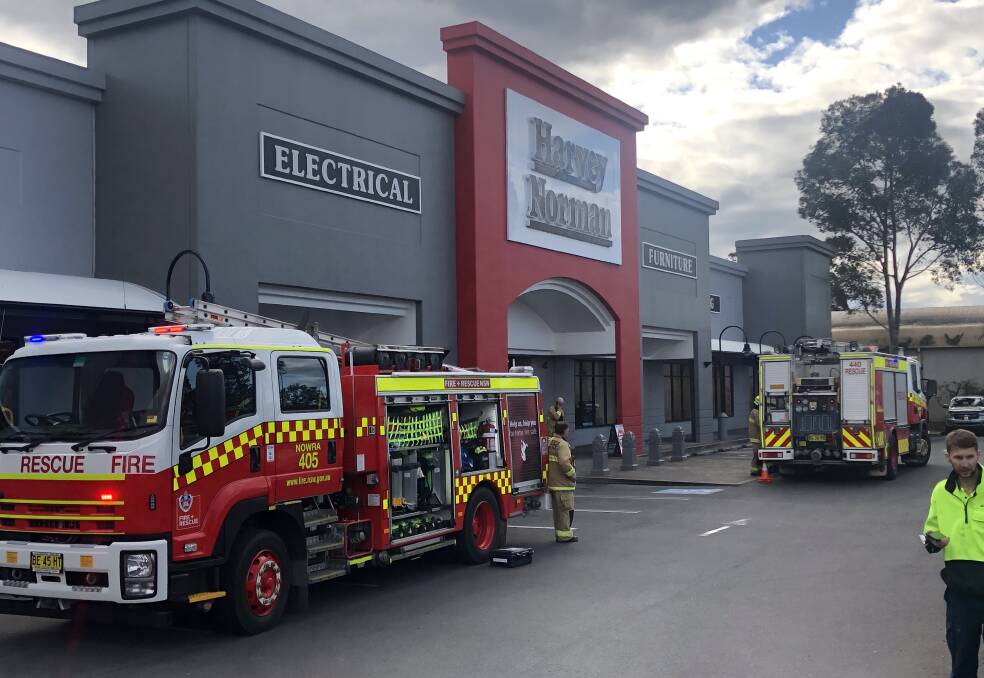 EVACUATED: Fire and Rescue NSW Shoalhaven and Nowra crews at Harvey Norman South Nowra on Monday.
