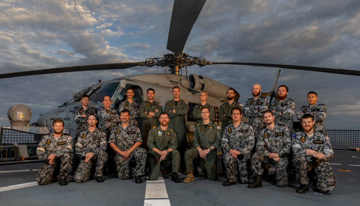 LOCAL TEAM: Aircrew and maintainers of 816 Squadron's Flight 3 and the embarked MH-60R Seahawk helicopter on the flight deck of HMAS Ballarat during Indian Ocean Deployment 20-1.Photo: Shane Cameron