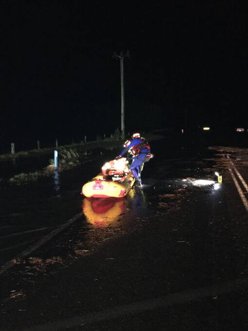 SUCCESS: Shoalhaven-based NSW Ambulance paramedic Irwin Burbage and his SES counterpart after their rescue of a stranded driver at Bolong in the early hours of Monday morning.